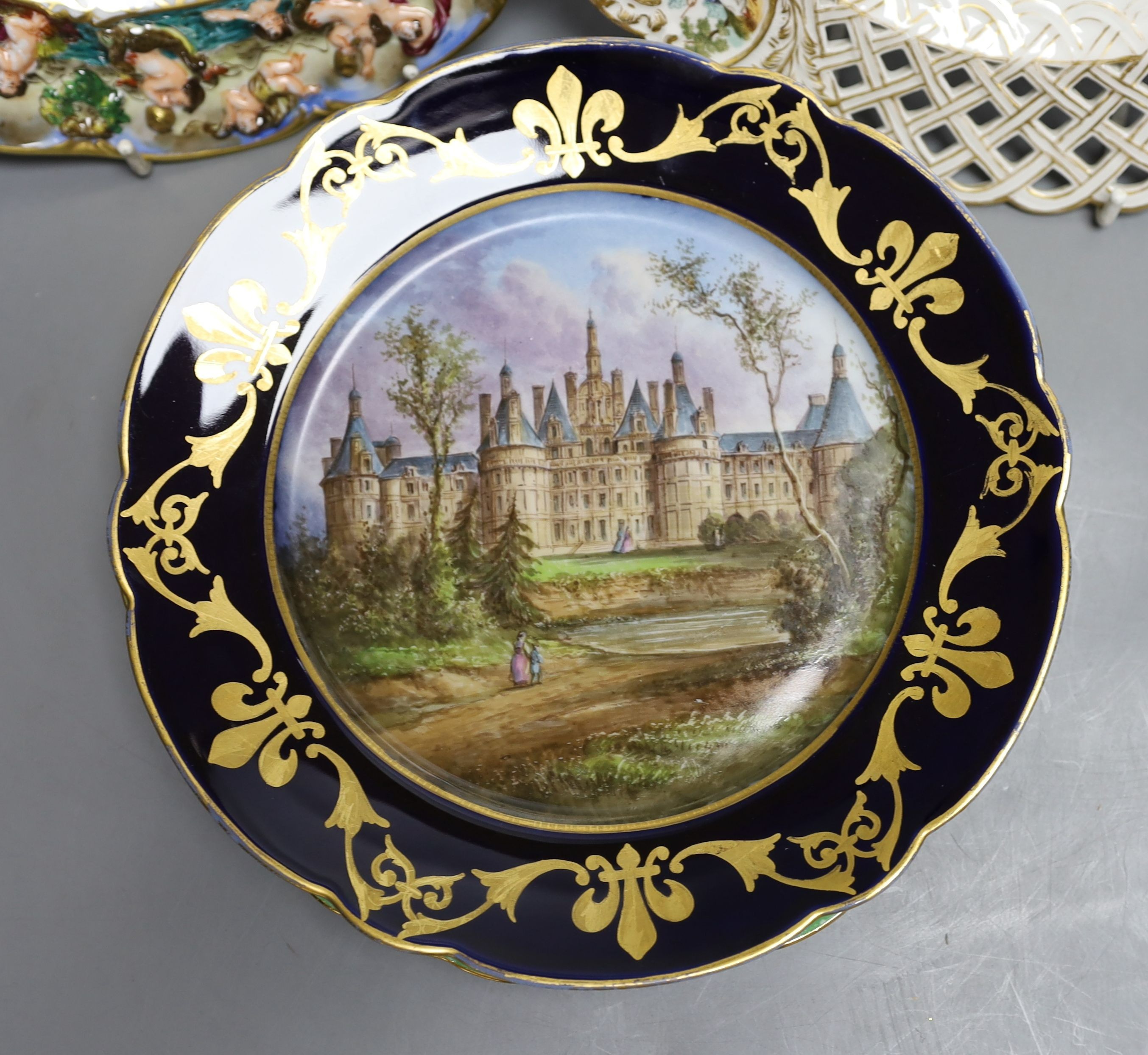 A Dresden armorial ribbon plate, two Sevres style plates and a Capodimonte style plate, late 19th/early 20th century (4)